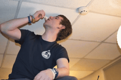 A Man Wearing A T-Shirt That Says ' California ' On The Front GIF