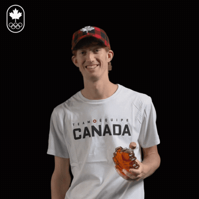 A Man Wearing A T-Shirt That Says Canada Drinks From A Bottle GIF