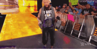 A Man Wearing A T-Shirt That Says I Got The America Is Walking Down A Ramp . GIF