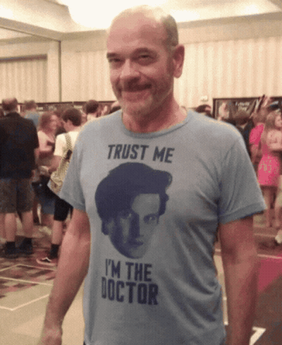 A Man Wearing A T-Shirt That Says " Trust Me I 'M The Doctor " GIF