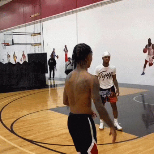 A Man Wearing A T-Shirt That Says Tyga Is Playing Basketball GIF