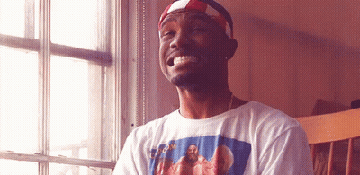 A Man Wearing A T-Shirt With A Picture Of Jesus On It Is Smiling GIF