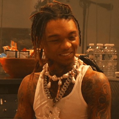 A Man Wearing A Tank Top And A Pearl Necklace GIF