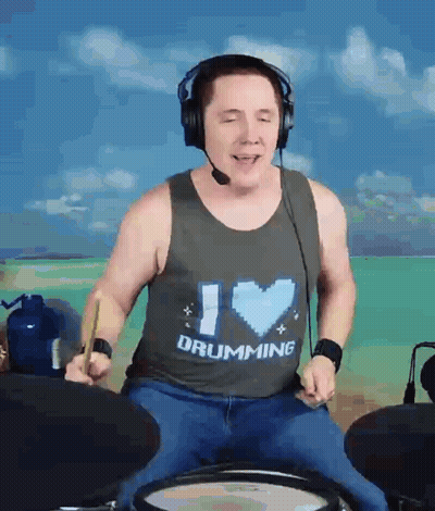 A Man Wearing A Tank Top That Says I Love Drumming GIF