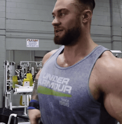 A Man Wearing A Tank Top That Says Under Armour On It GIF