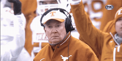 A Man Wearing A Texas Hat And Headphones Watches A Football Game GIF