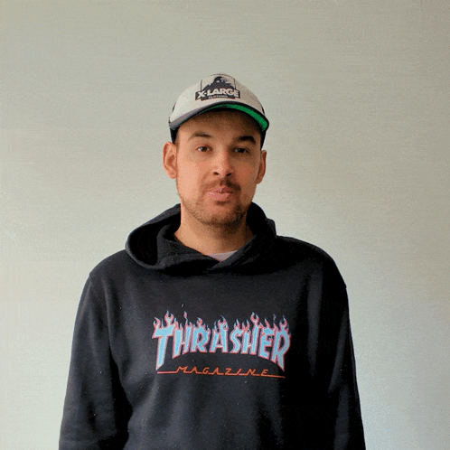 A Man Wearing A Thrasher Hoodie And A Hat GIF
