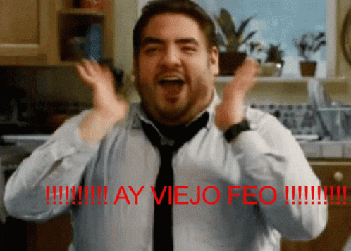 A Man Wearing A Tie And A Shirt With The Words Ay Viejo Feo On The Bottom GIF
