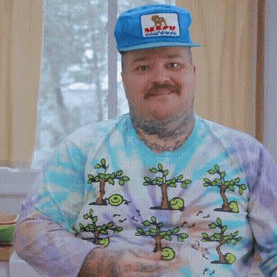 A Man Wearing A Tie Dye Shirt And A Blue Hat Says That Was A Lot GIF