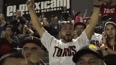 A Man Wearing A Toaus Jersey Stands In A Crowd GIF