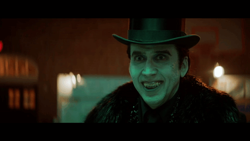 A Man Wearing A Top Hat And A Fur Coat Is Making A Funny Face GIF