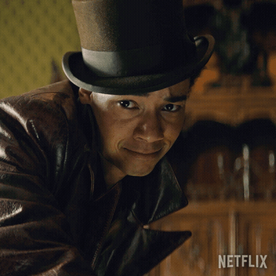 A Man Wearing A Top Hat And A Leather Jacket With A Netflix Logo In The Corner GIF