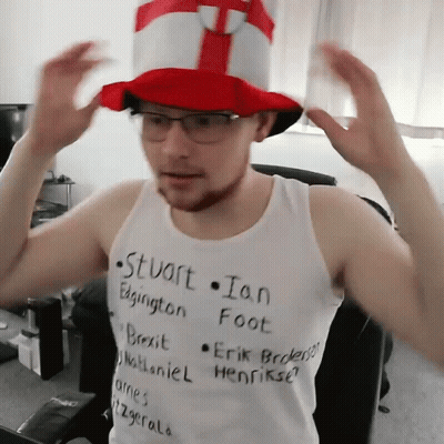A Man Wearing A Top Hat And A Tank Top That Says Stuart Ian Edgington Foot GIF