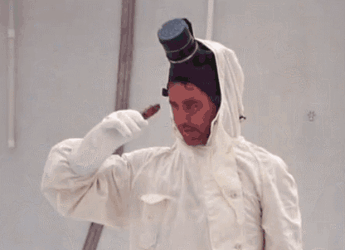 A Man Wearing A Top Hat And A White Coat GIF