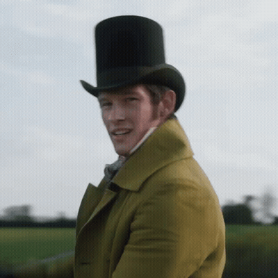 A Man Wearing A Top Hat And A Yellow Coat Is Waving GIF