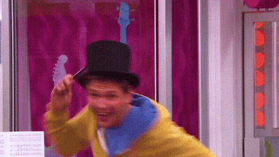 A Man Wearing A Top Hat And A Yellow Jacket GIF