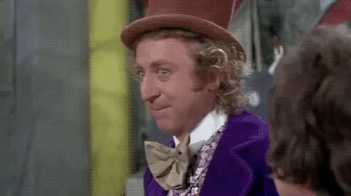 A Man Wearing A Top Hat And Bow Tie Is Smiling . GIF