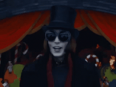 a man wearing a top hat and sunglasses is standing in front of candy canes