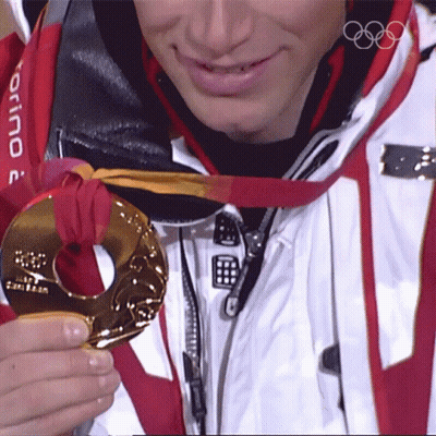 A Man Wearing A Torino Jacket Is Holding A Medal GIF