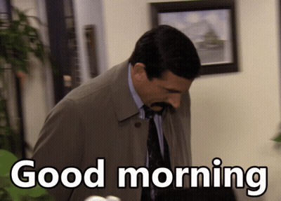 A Man Wearing A Trench Coat And Tie Says Good Morning GIF
