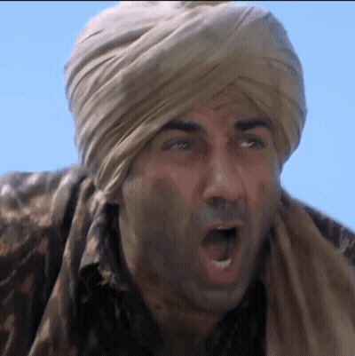 A Man Wearing A Turban And A Scarf Is Making A Funny Face GIF
