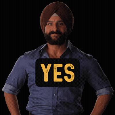 A Man Wearing A Turban Has A Yes Sign On His Shirt GIF