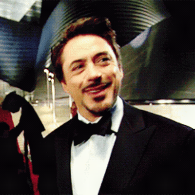 A Man Wearing A Tuxedo And Bow Tie Is Smiling GIF