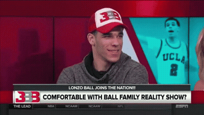 A Man Wearing A Ucla Jersey Is Talking To A Woman On A Tv Show GIF