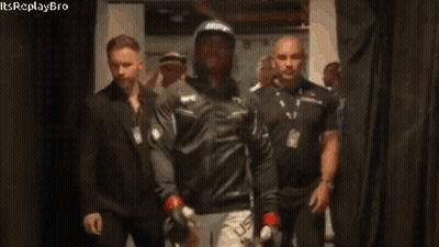 A Man Wearing A Ufc Hat Walks Through A Hallway GIF