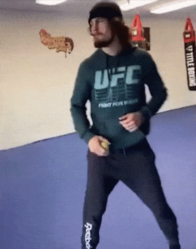 A Man Wearing A Ufc Hoodie Is Dancing GIF