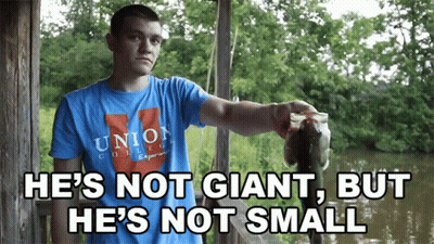 A Man Wearing A Union College Shirt Holds A Large Fish GIF