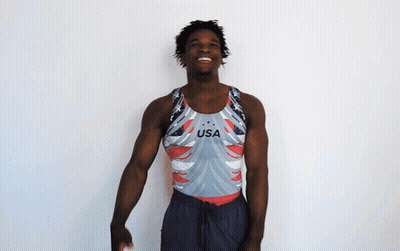 A Man Wearing A Usa Tank Top Is Smiling GIF