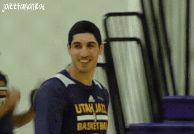 A Man Wearing A Utah Jazz Basketball Shirt Smiles GIF