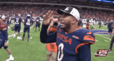 A Man Wearing A Utsa Jersey Stands On A Field GIF