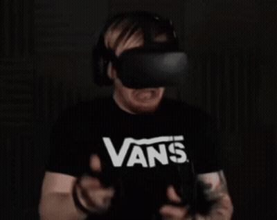 A Man Wearing A Vans T-Shirt Is Playing A Virtual Reality Game . GIF
