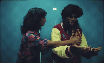 A Man Wearing A Varsity Jacket With The Letter J On The Front GIF