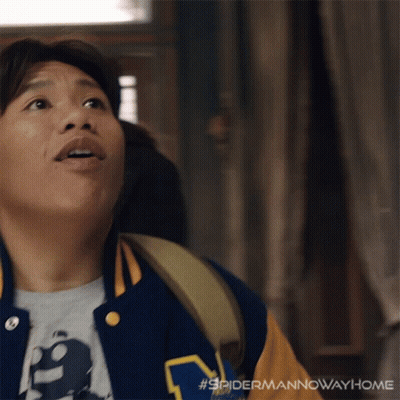 A Man Wearing A Varsity Jacket With The Letter M On The Front GIF