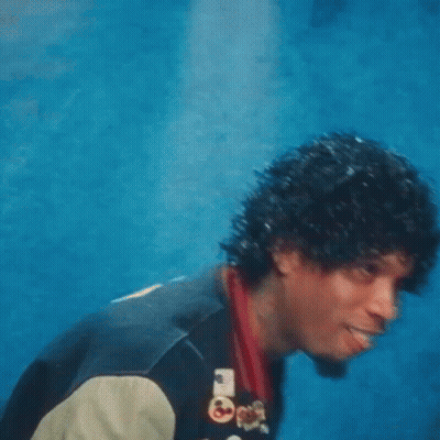 A Man Wearing A Varsity Jacket With The Letter R On The Front GIF