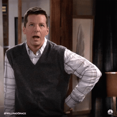 A Man Wearing A Vest And A Plaid Shirt Has His Hands On His Hips GIF