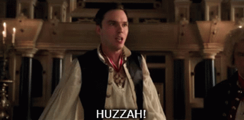 A Man Wearing A Vest And A White Shirt Says Huzzah GIF