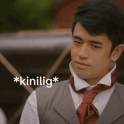 A Man Wearing A Vest And Tie Has The Word * Kinilig * On The Bottom Right GIF