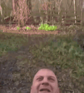 A Man Wearing A Vest And Tie Is Screaming With His Mouth Wide Open . GIF