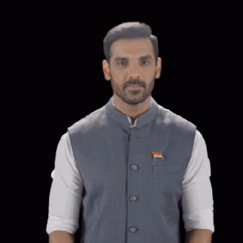 A Man Wearing A Vest With An Indian Flag On It Holds His Hand Up GIF