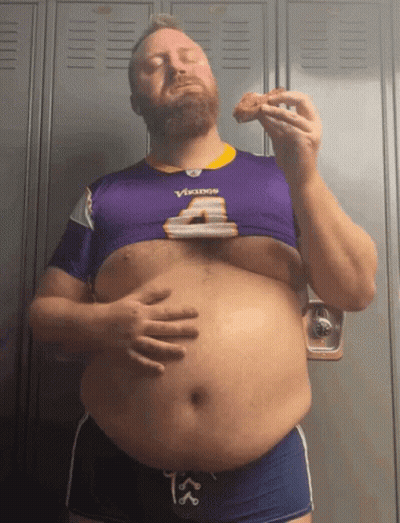 A Man Wearing A Vikings Jersey Is Eating A Slice Of Pizza GIF