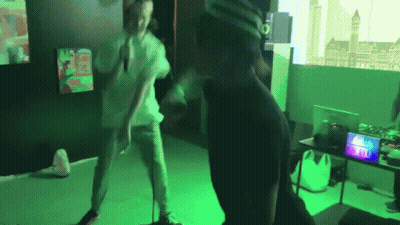 A Man Wearing A Virtual Reality Headset Is Dancing In A Room GIF