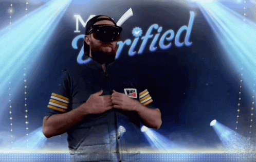 A Man Wearing A Virtual Reality Headset Is Standing In Front Of A Sign That Says Verified GIF