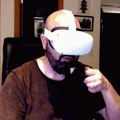 A Man Wearing A Virtual Reality Headset With A Christmas Tree In The Background GIF