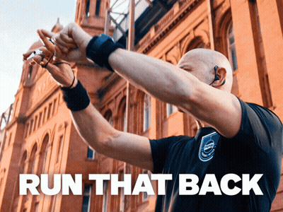 A Man Wearing A Volvo Shirt Holds His Hands In The Air GIF