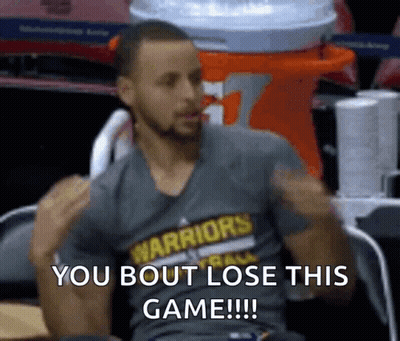 A Man Wearing A Warriors Shirt Is Sitting In A Chair With His Arms In The Air . GIF