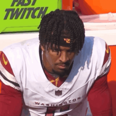A Man Wearing A Washington Football Jersey And A Headband . GIF